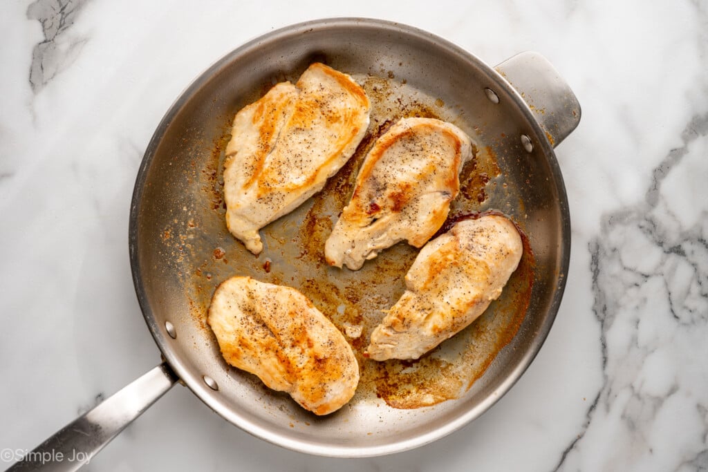 Overhead of skillet of chicken breasts to make marry me chicken