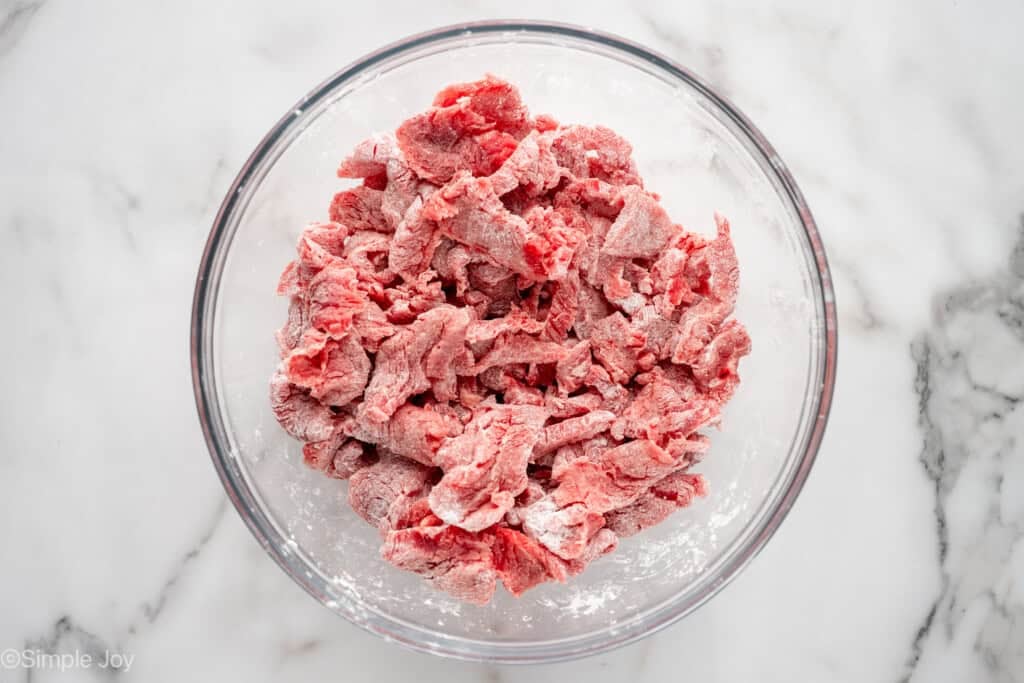 overhead of glass bowl of beef to make Mongolian Beef