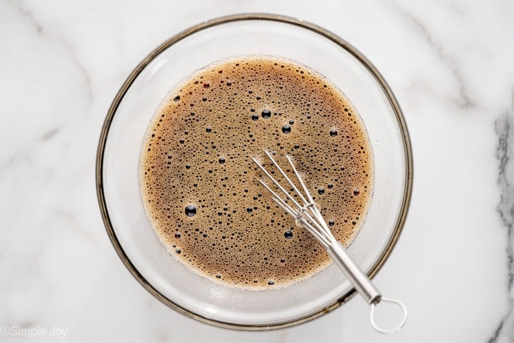 overhead of bowl of Mongolian Beef sauce ingredients and whisk