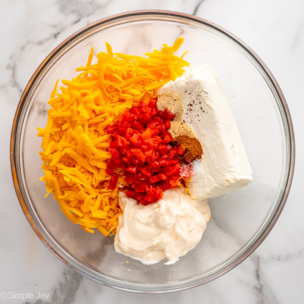Overhead view of a mixing bowl of ingredients for Pimento Cheese recipe