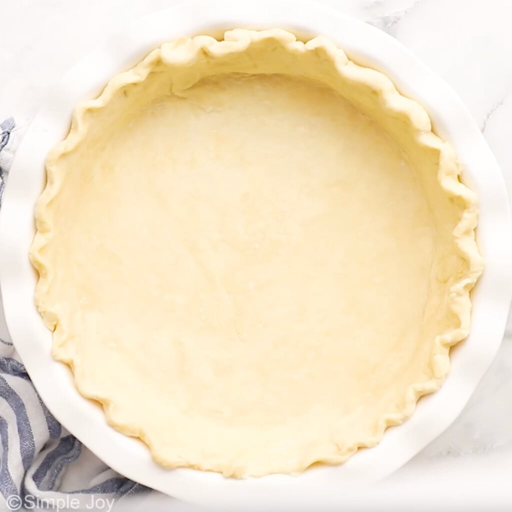 overhead of homemade pie crust in a pie plate to make spinach quiche