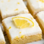 Sliced Lemon Sugar Cookie Bars garnished with lemon zest and slices of lemon.