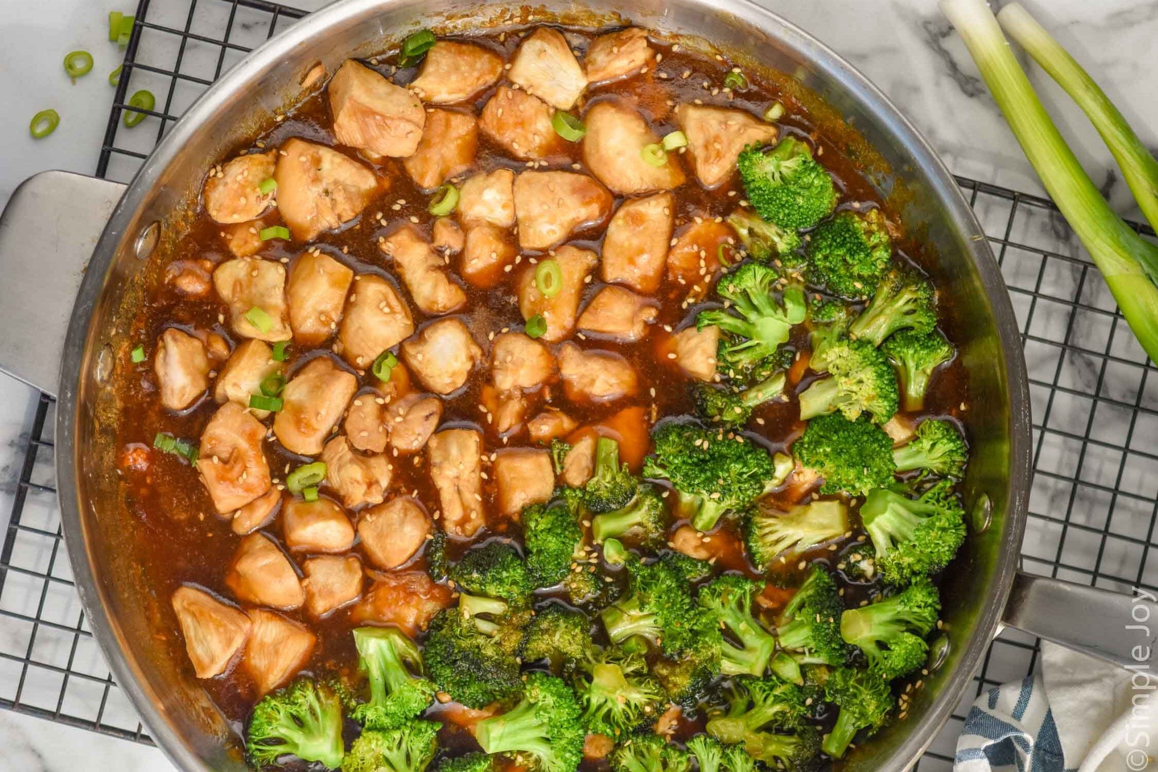 Overhead photo of teriyaki chicken rice bowl recipe in a skillet with broccoli.