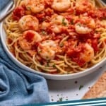 Pinterest graphic for Shrimp Fra Diavolo. Image shows a plate of pasta topped with Shrimp Fra Diavolo. Says "Shrimp Fra Diavolo simplejoy.com"
