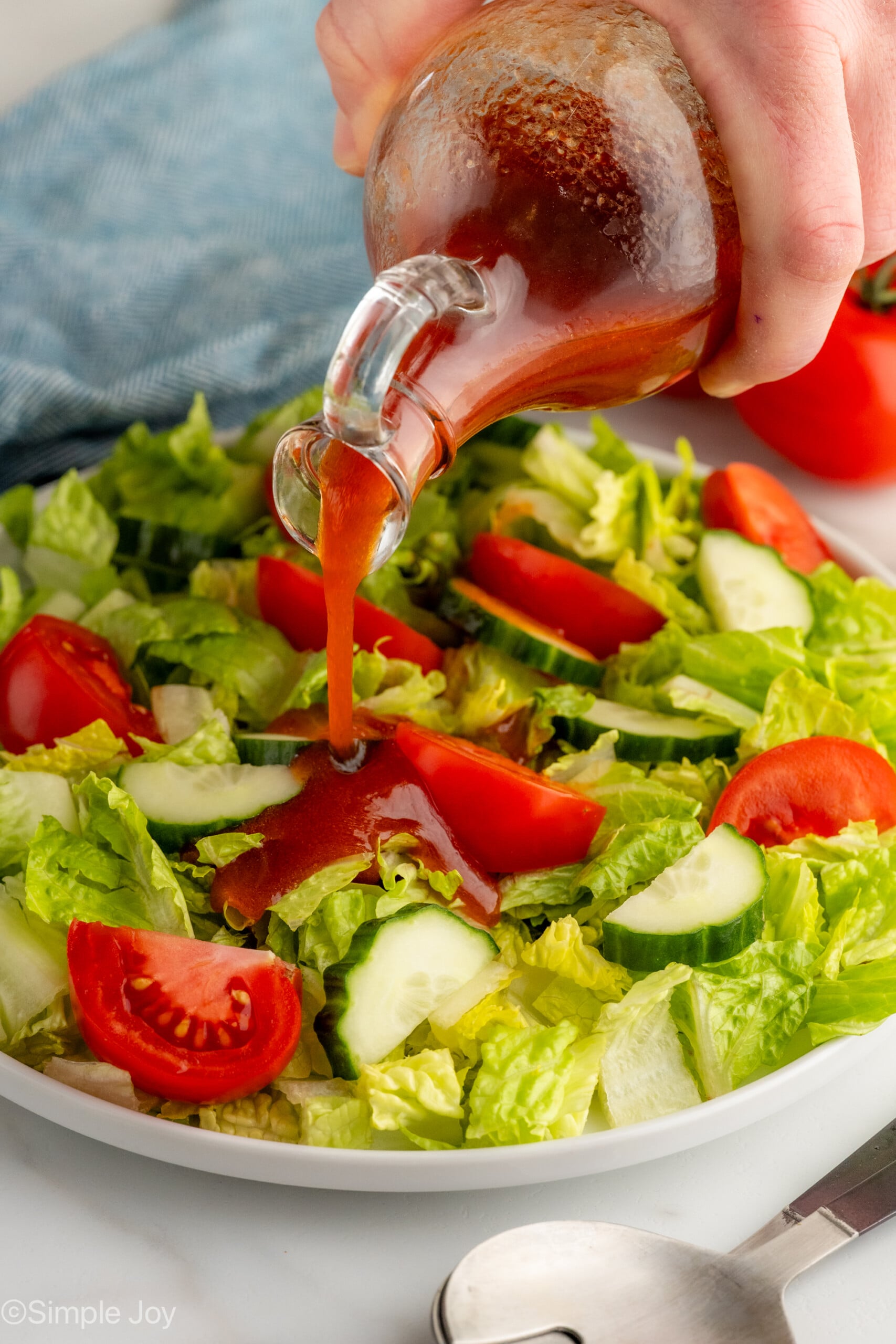 catalina dressing being poured on a salad