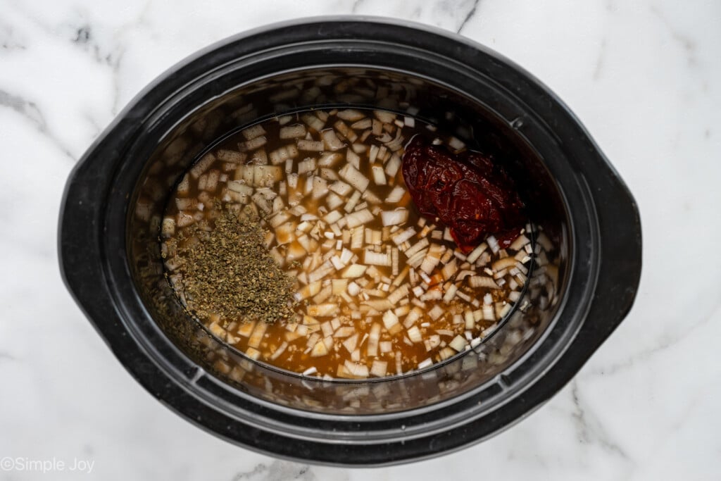 Overhead of beef barbacoa ingredients in a crockpot