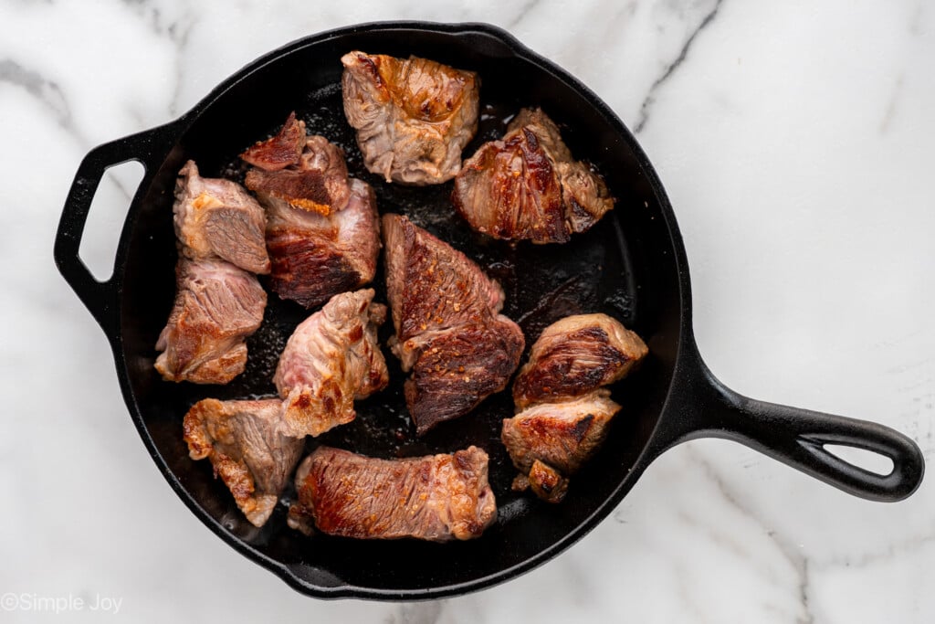overhead of skillet of beef in skillet to make beef barbacoa recipe