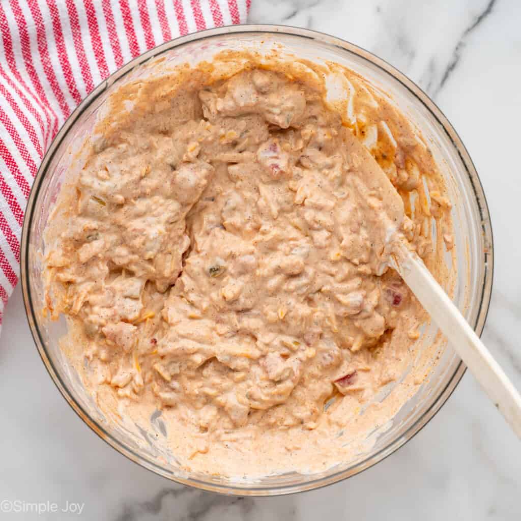 Overhead of glass bowl of Boat Dip recipe with rubber spatula