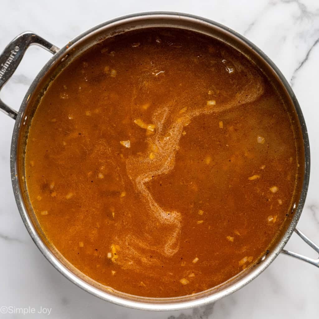 overhead of saucepan of chicken and rice recipe ingredients
