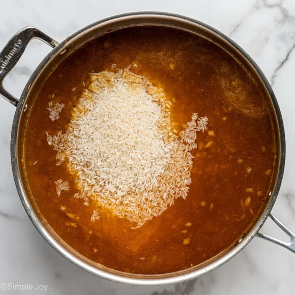 overhead of saucepan of chicken and rice recipe ingredients