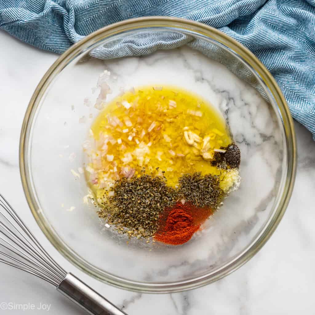 Overhead of glass bowl of Greek Chicken ingredients