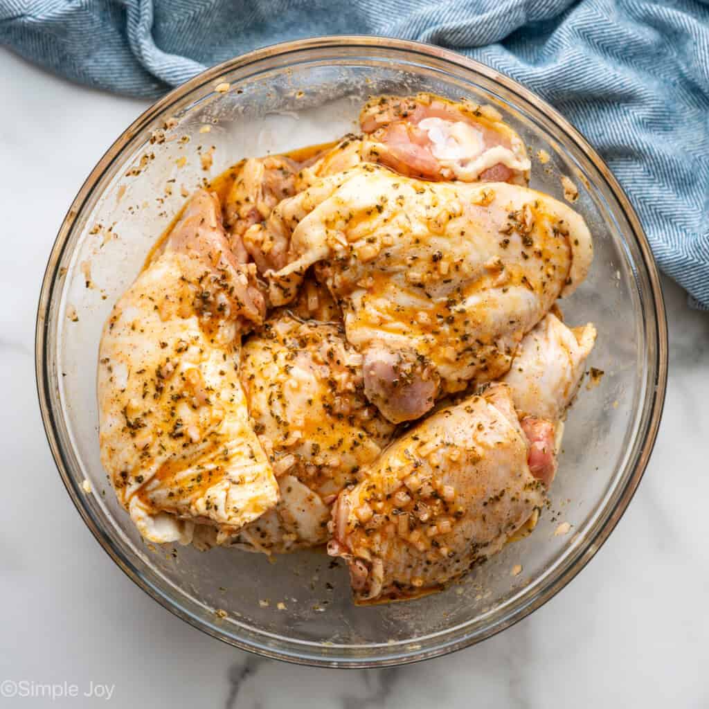 Overhead of glass bowl of Greek Chicken ingredients