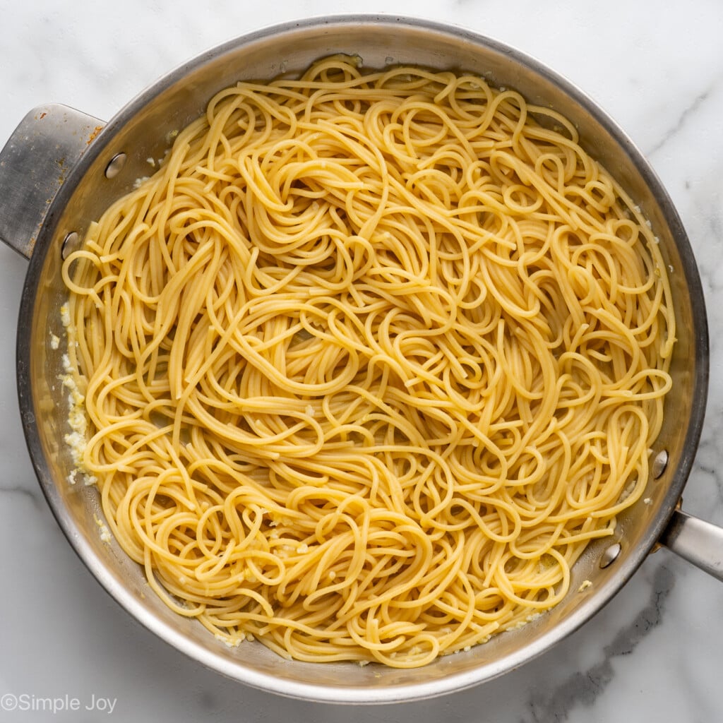 Overhead of cooked pasta in skillet to make lemon pasta recipe