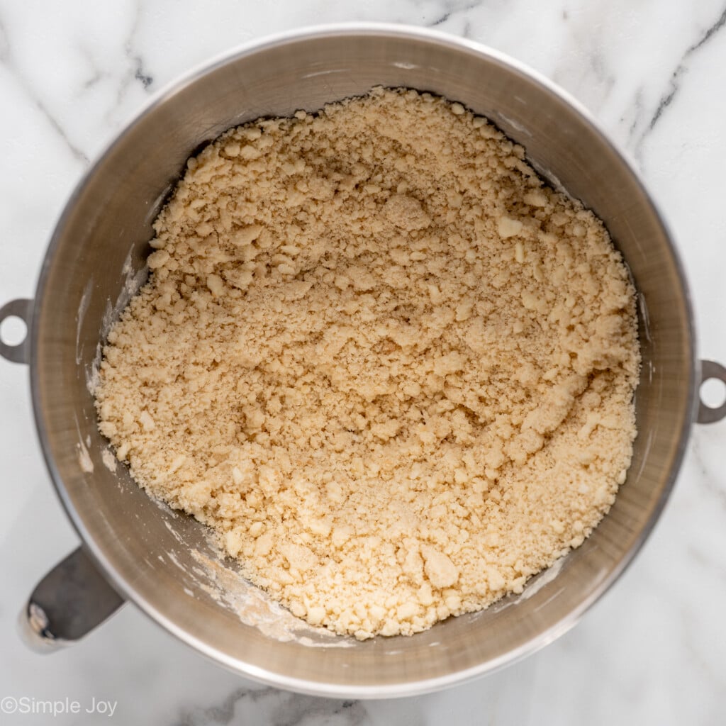overhead of metal mixing bowl of shortbread cookie recipe ingredients