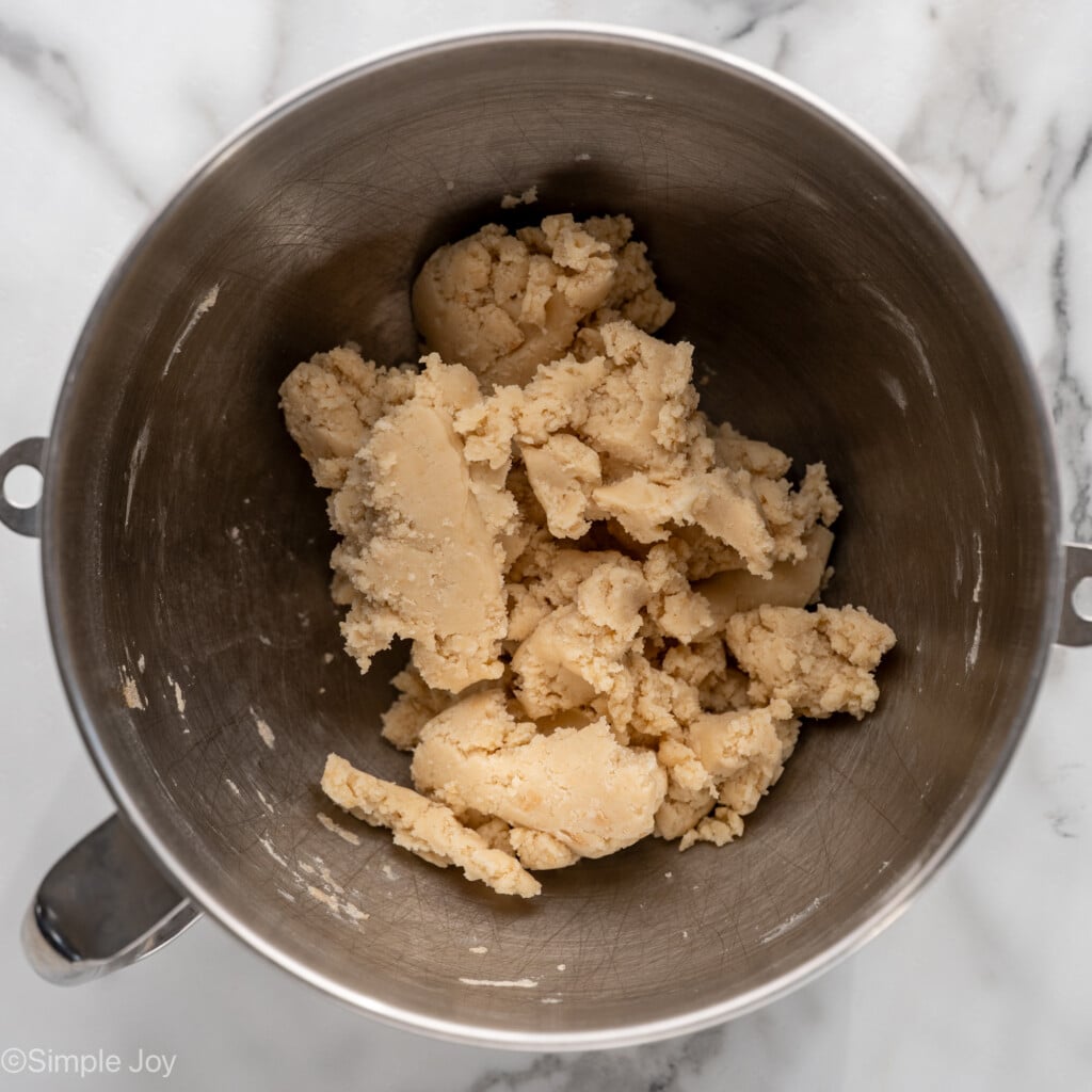 overhead of metal mixing bowl of shortbread cookie dough to make homemade shortbread cookies