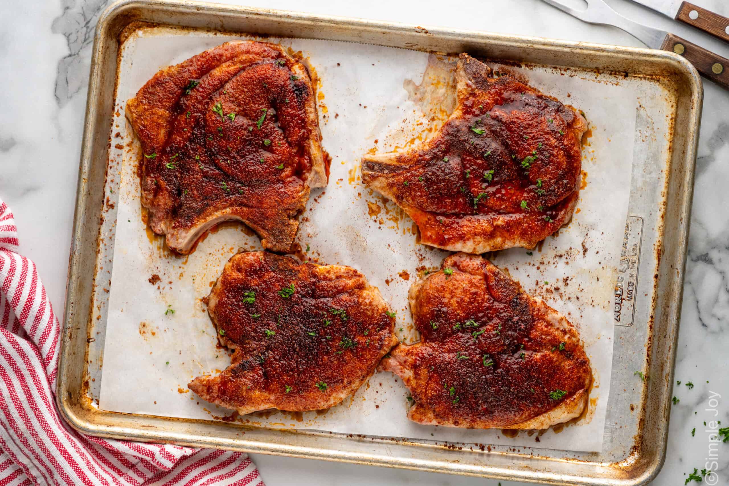 overhead of Baked Pork Chops on a baking sheet
