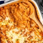 Pinterest graphic for Five Ingredient Baked Ziti. Says "5 ingredients easy baked ziti recipe simplejoy.com" Image shows overhead of baking dish of Five Ingredient Baked Ziti with wooden spoon.