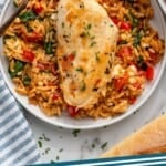 Pinterest graphic for Mediterranean Chicken and Orzo. Image shows overhead of plate of Mediterranean Chicken and Orzo with a fork. Says "Mediterranean Chicken and Orzo simplejoy.com"