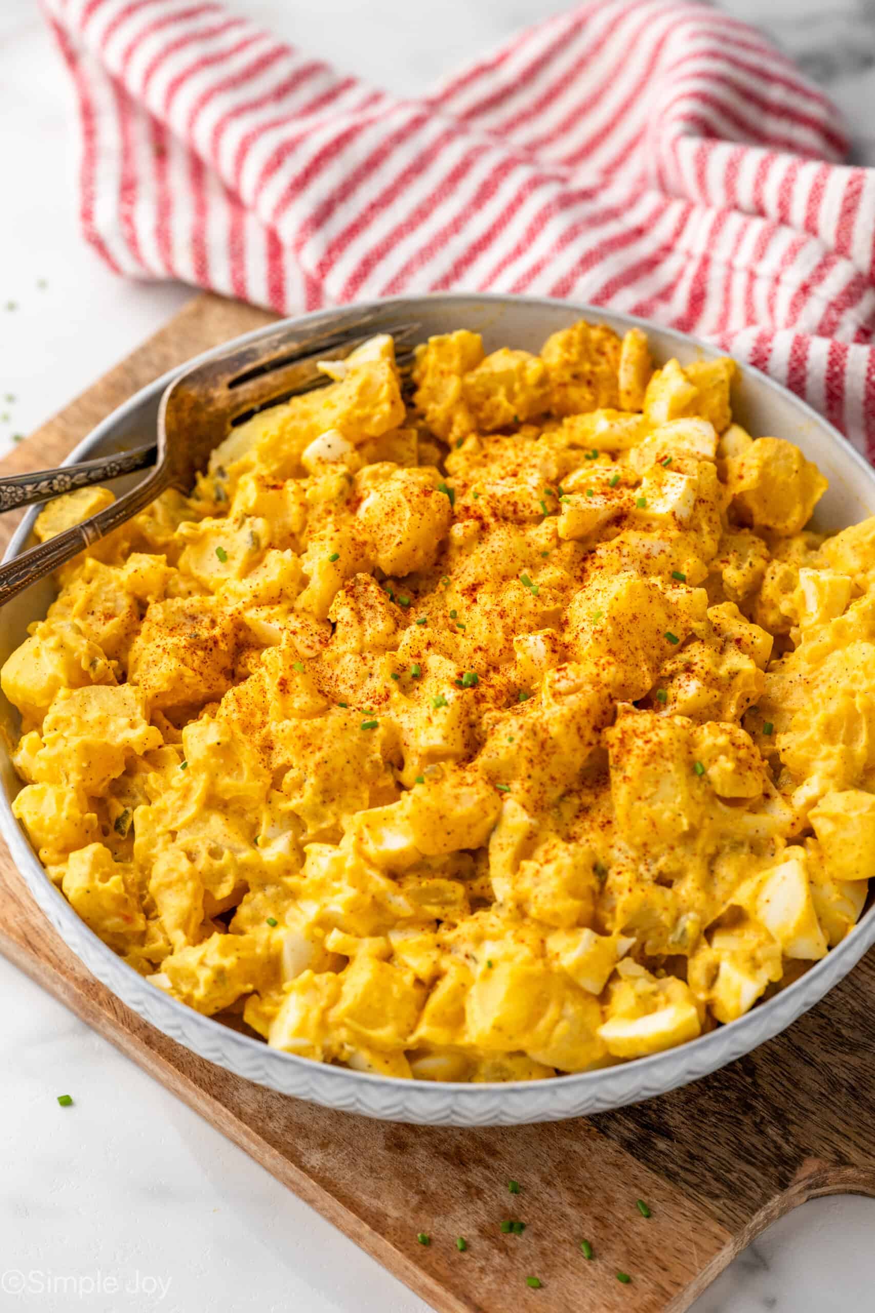 Bowl of Deviled Egg Potato Salad with two forks