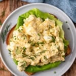 overhead of plate of Cottage Cheese Egg Salad on bread, garnished with fresh dill