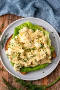 overhead of plate of Cottage Cheese Egg Salad on bread, garnished with fresh dill