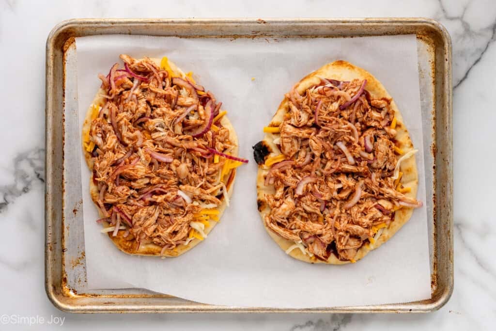 Overhead of baking sheet with BBQ Chicken Flatbread Pizza ingredients