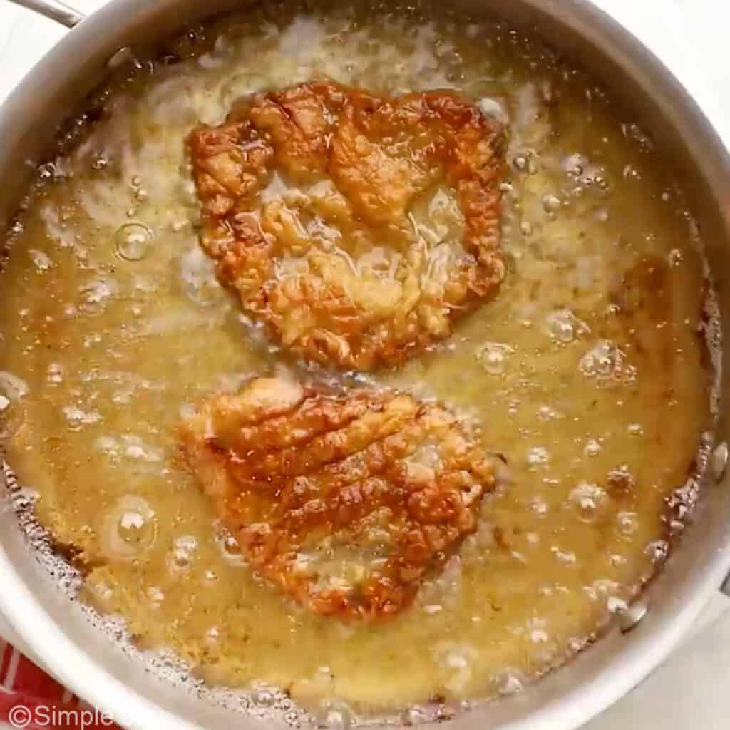 Overhead of skillet of oil cooking steak for Chicken Fried Steak recipe