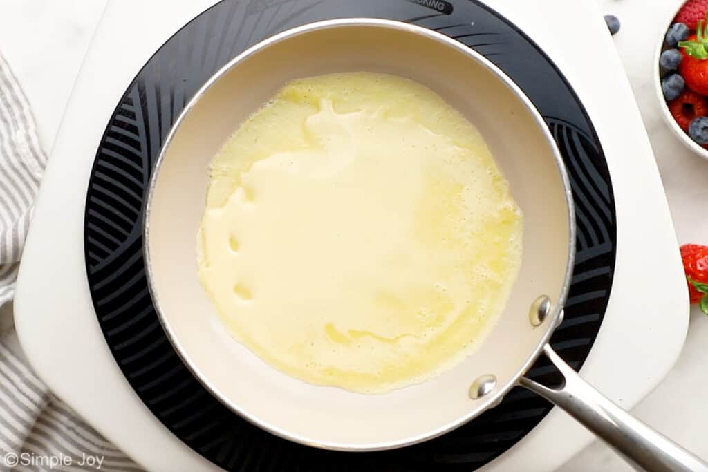 Overhead of crepe batter in a skillet