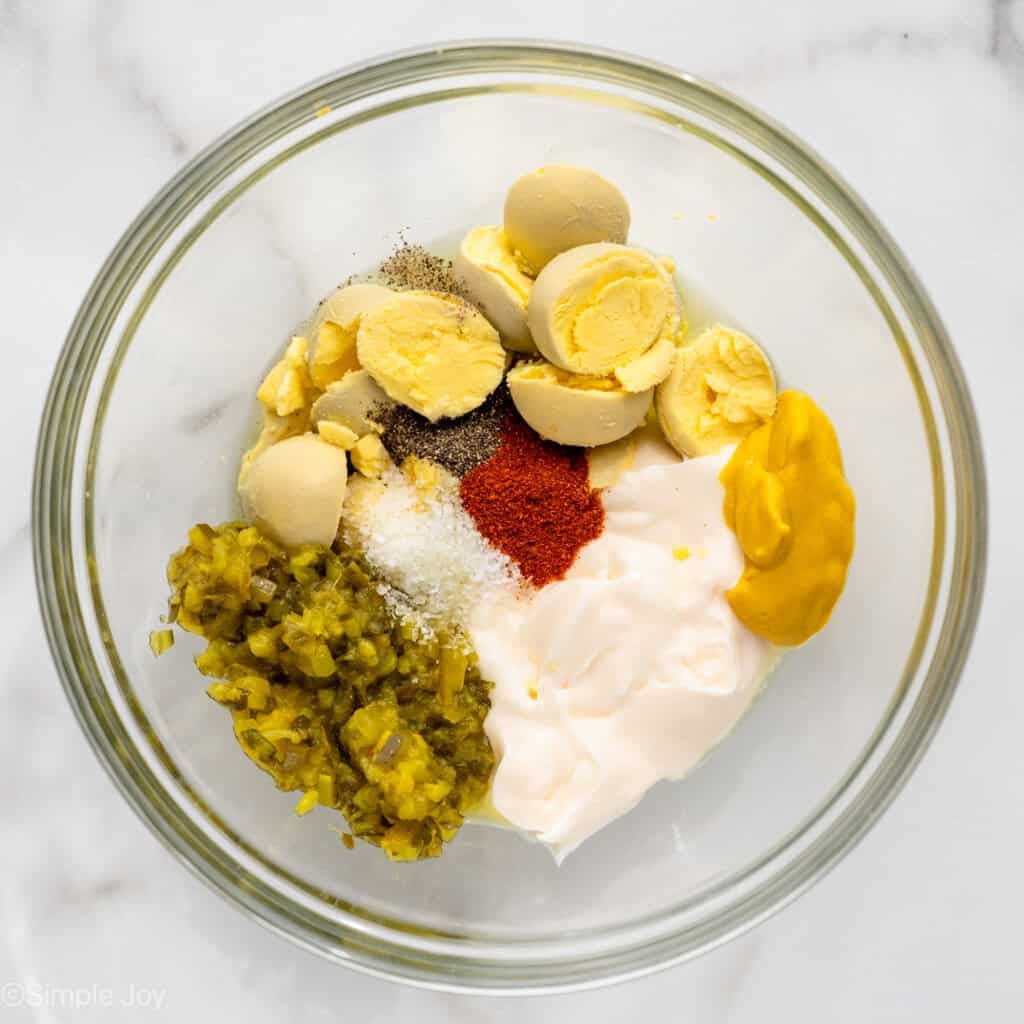 Overhead of bowl of Deviled Egg Potato Salad ingredients