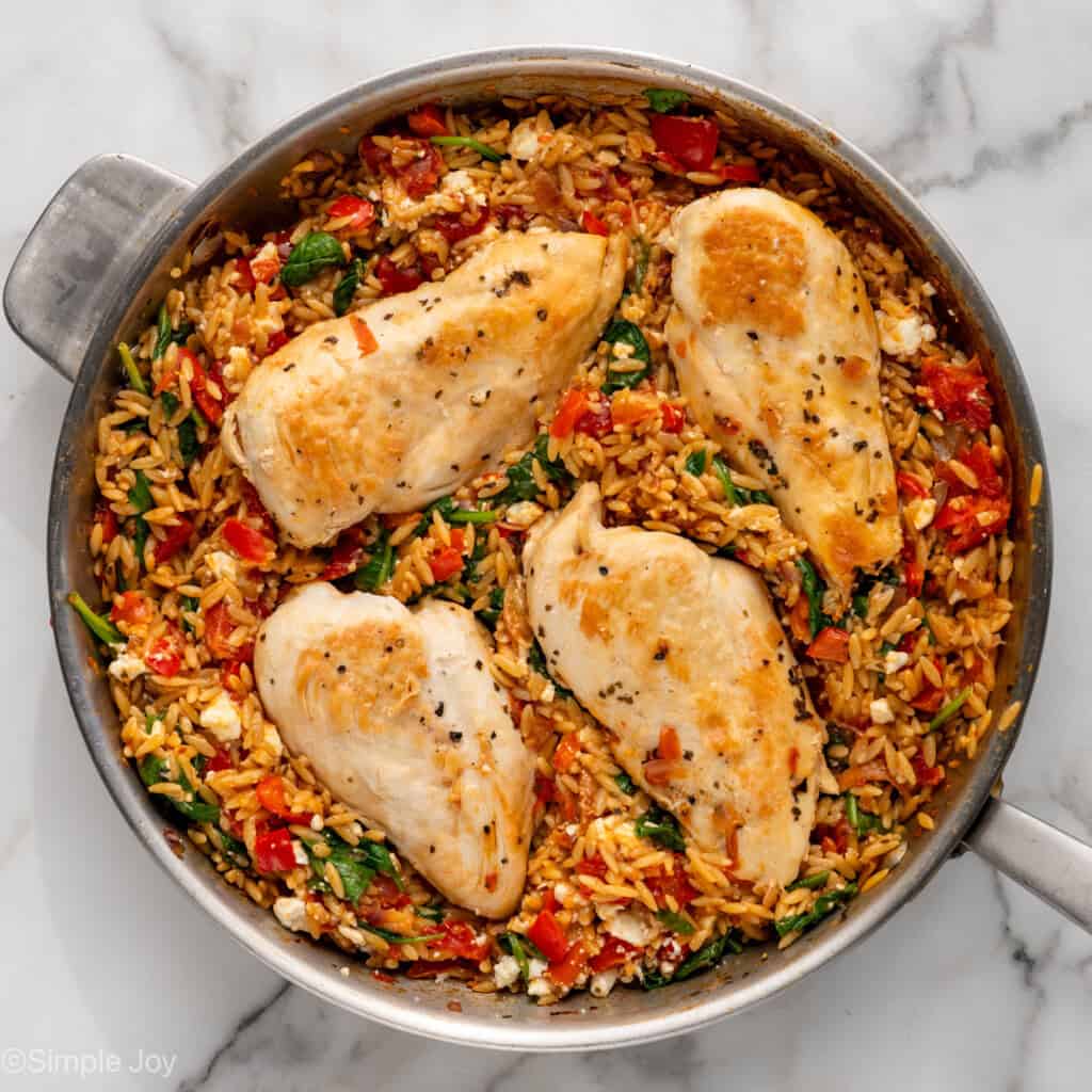 Overhead of skillet of Mediterranean Chicken and Orzo recipe