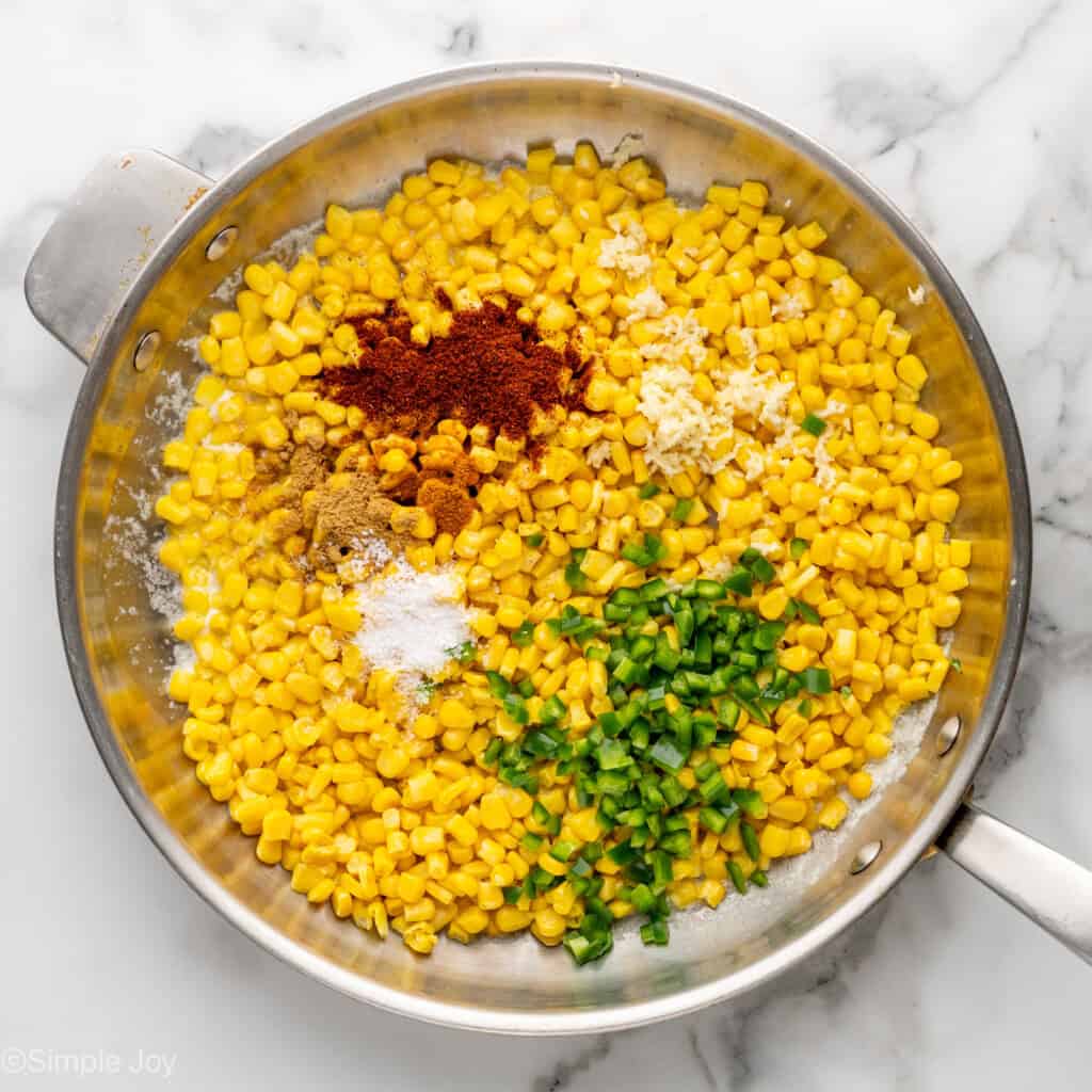 Overhead of skillet of Mexican Street Corn Dip ingredients
