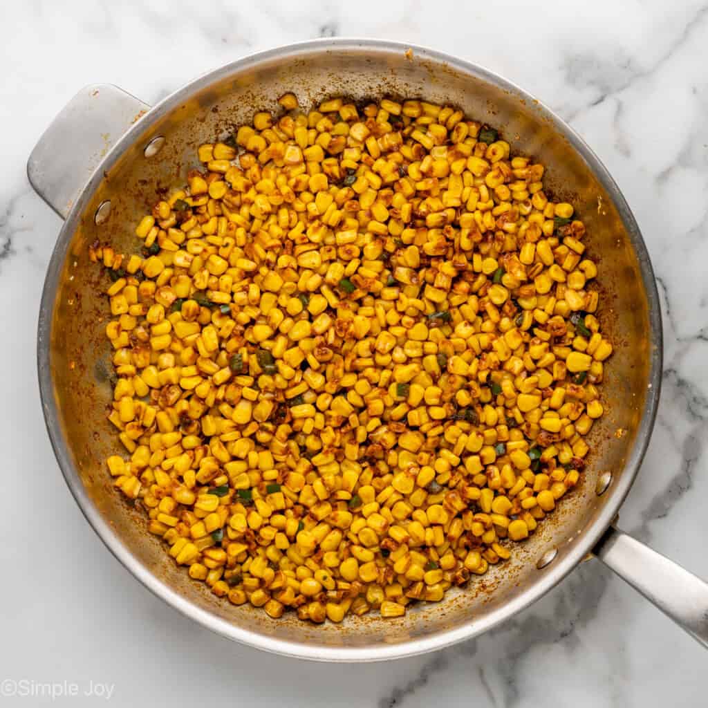 Overhead of skillet of corn to make Mexican Street Corn Dip recipe