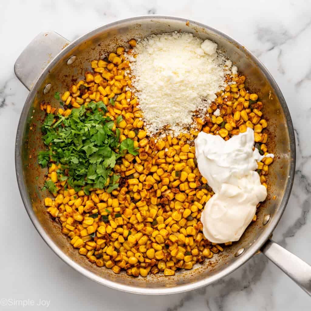 Overhead of skillet of Mexican Street Corn Dip ingredients