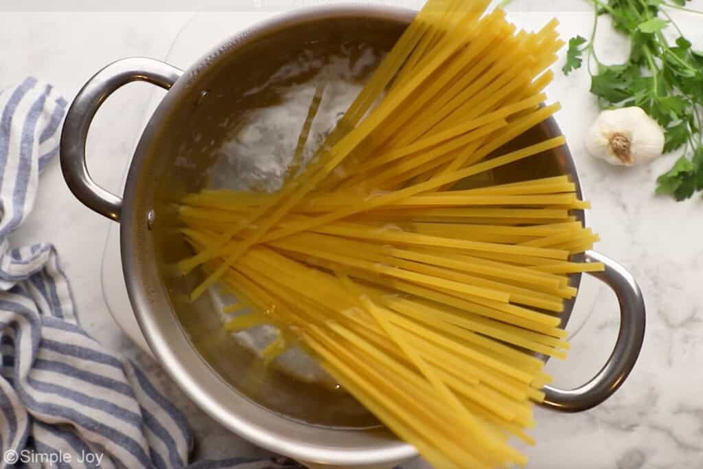 Overhead of pot of boiling water and pasta to make Shrimp Alfredo