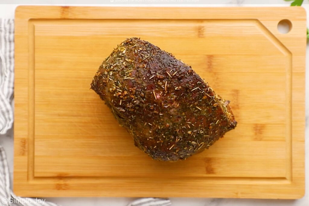 Overhead of sirloin tip roast on a wooden cutting board