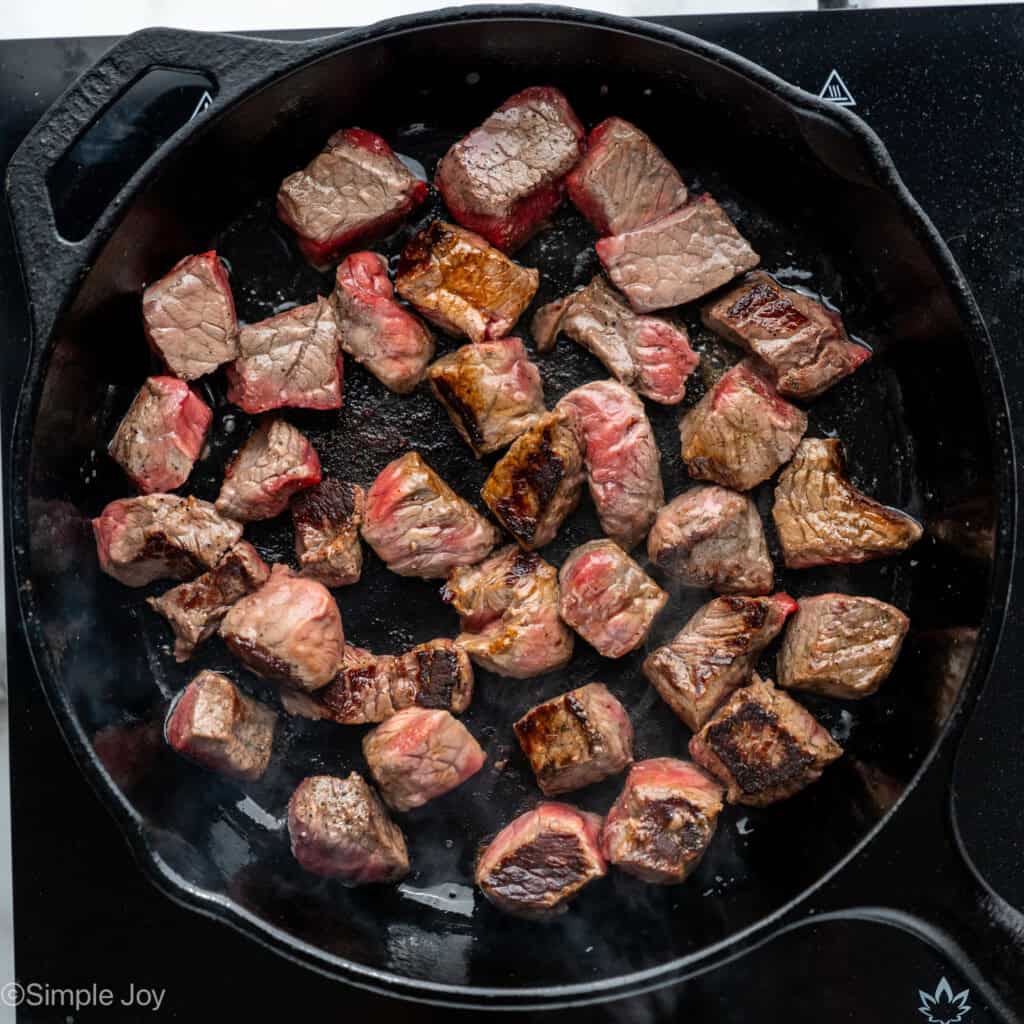 Overhead of skillet of Garlic Butter Steak Bites cooking