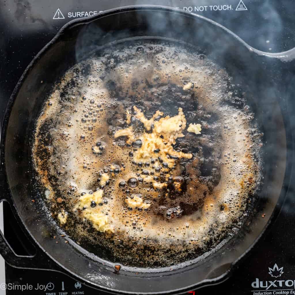 Overhead of skillet of Garlic Butter Steak Bites ingredients