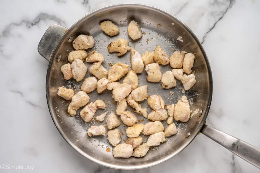 Overhead of skillet of diced chicken to make Sweet and Sour Chicken