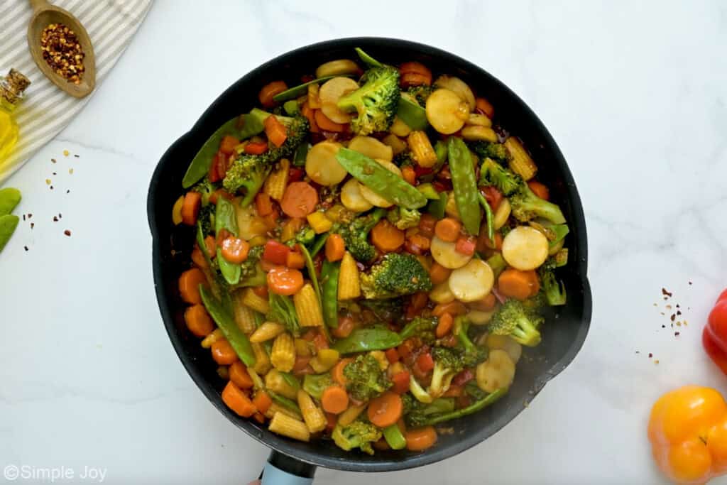 Overhead of cast iron skillet of vegetable stir fry ingredients