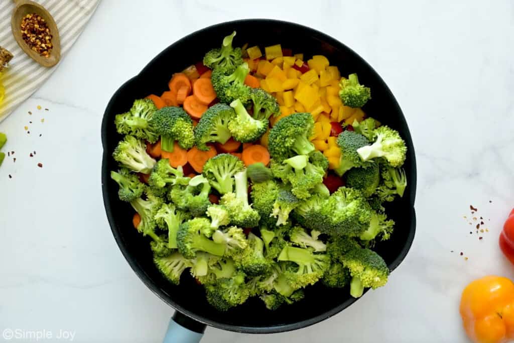 Overhead of cast iron skillet of raw vegetables to make vegetable stir fry recipe