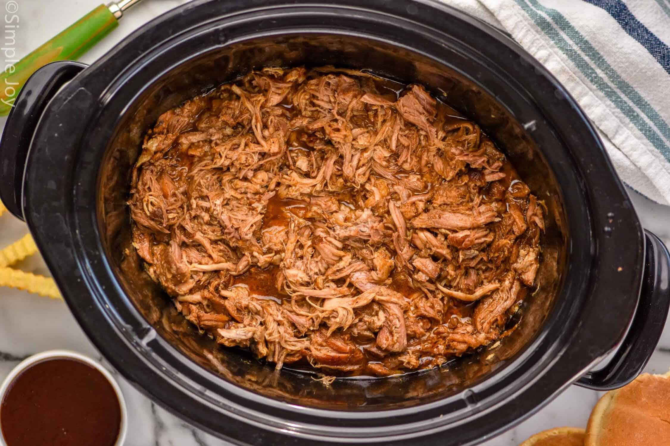Overhead view of a slow cooker of Crock Pot Pulled Pork recipe