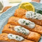Pinterest graphic for Broiled Salmon with Lemon Dill Sauce. Says "the best salmon & dill sauce simplejoy.com" Image shows plate of Broiled Salmon topped with Lemon Dill Sauce, garnished with lemon slices and fresh dill.