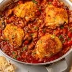 Pinterest graphic for Chicken Cacciatore. Image shows a skillet of Chicken Cacciatore with two glasses of red wine beside. Says "super easy Chicken Cacciatore simplejoy.com"
