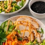 Pinterest graphic for Honey Sriracha Chicken Bowl recipe. Says "Honey Sriracha Chicken Bowl simplejoy.com" Image shows a Honey Sriracha Chicken Bowl with bowl of sesame seeds in background