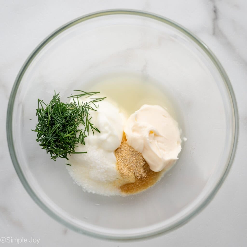 Overhead of bowl of Lemon Dill Sauce ingredients for broiled salmon recipe