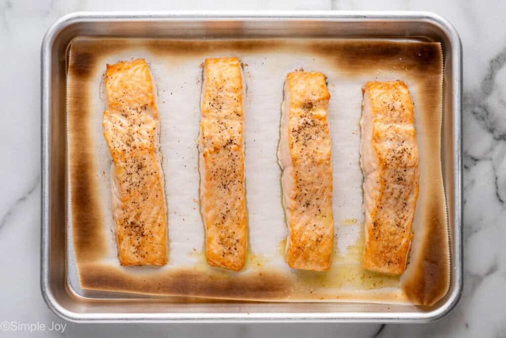 Overhead of broiled salmon on a baking sheet