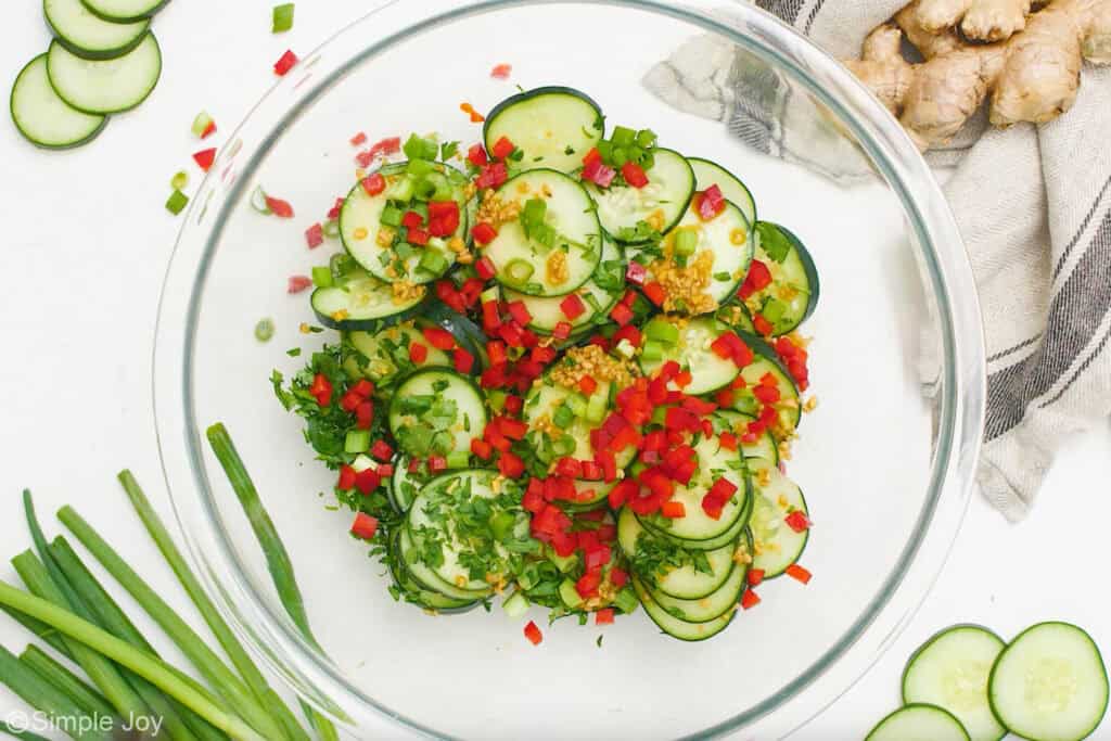 Overhead of glass bowl of asian cucumber salad ingredients
