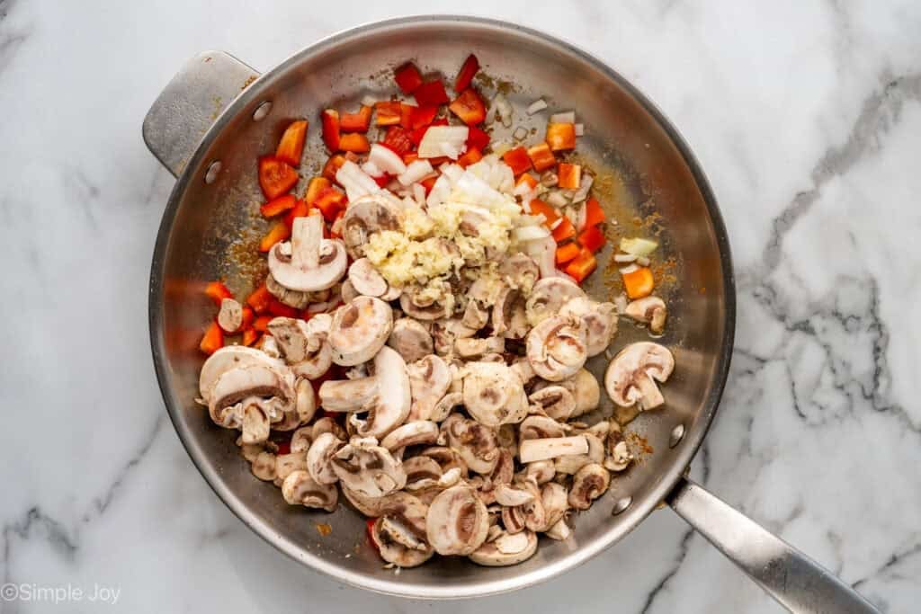 Overhead of skillet of Chicken Cacciatore ingredients