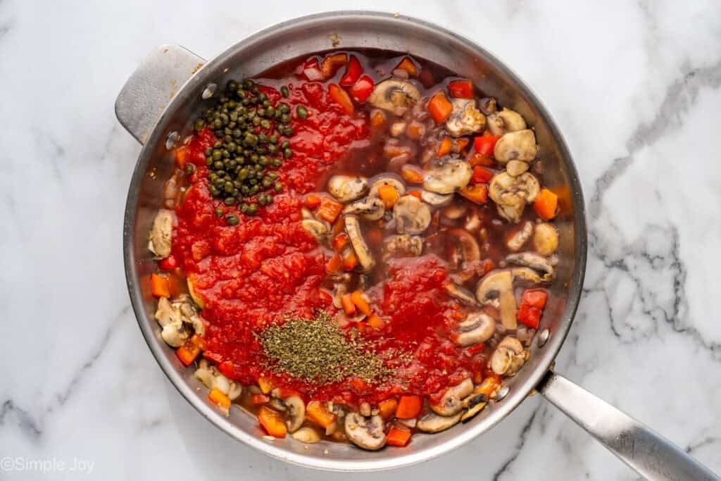 Overhead of skillet of Chicken Cacciatore ingredients