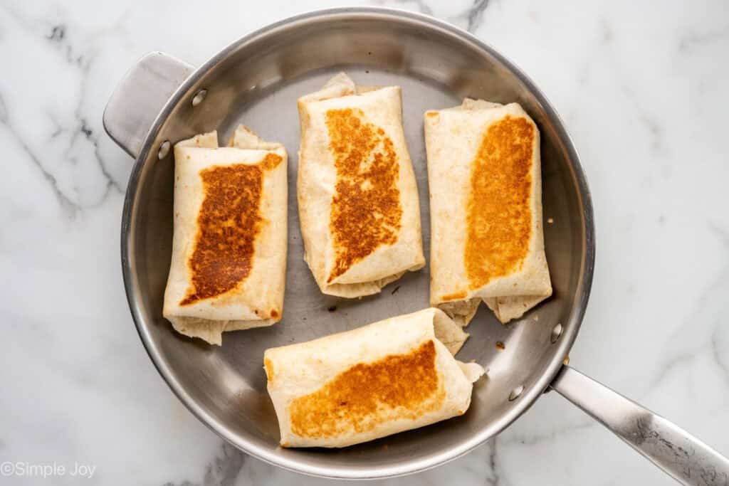 Overhead of skillet of crack chicken wraps
